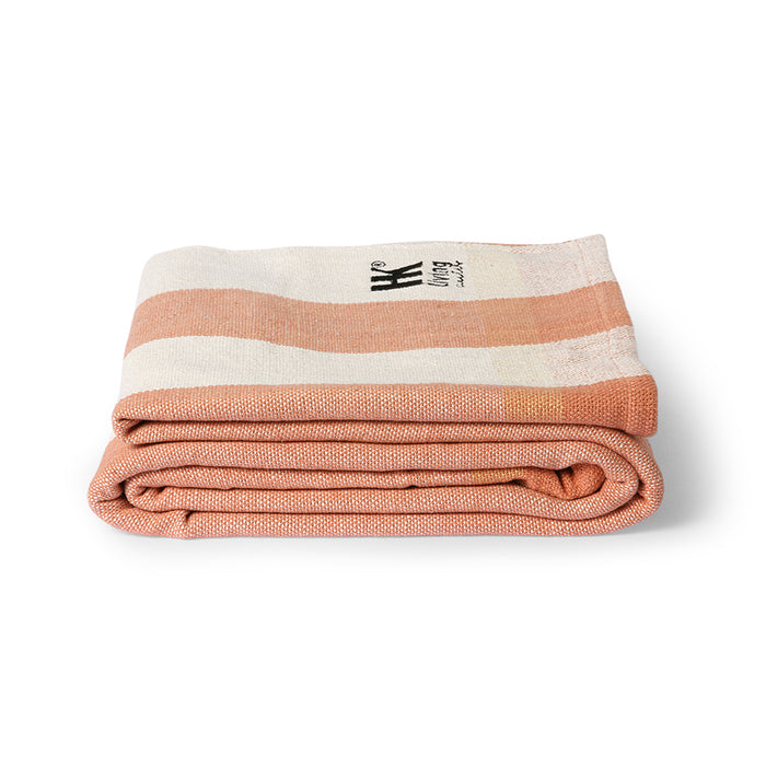 folded striped beach blanket with peach stripes
