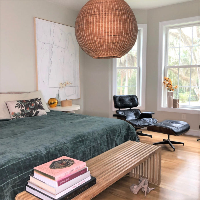 mid century modern bedroom with large abstract painting and Eames chair