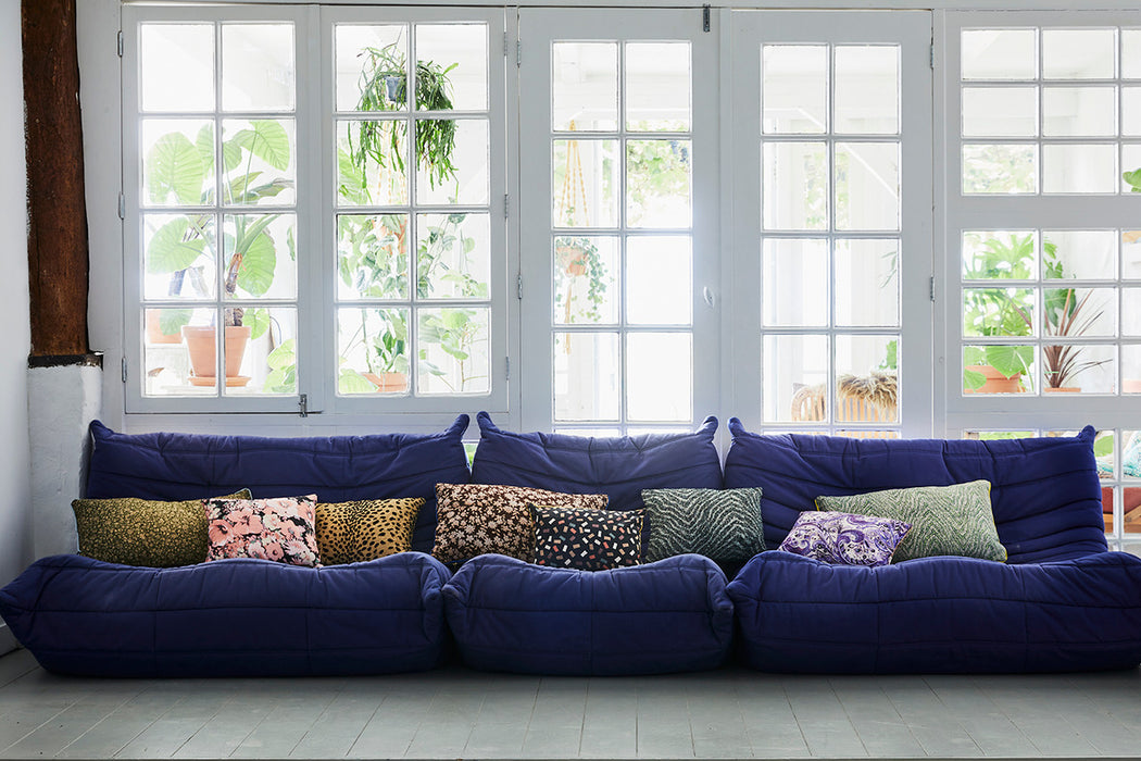 blue element sofa with lumbar pillows in various prints and textures