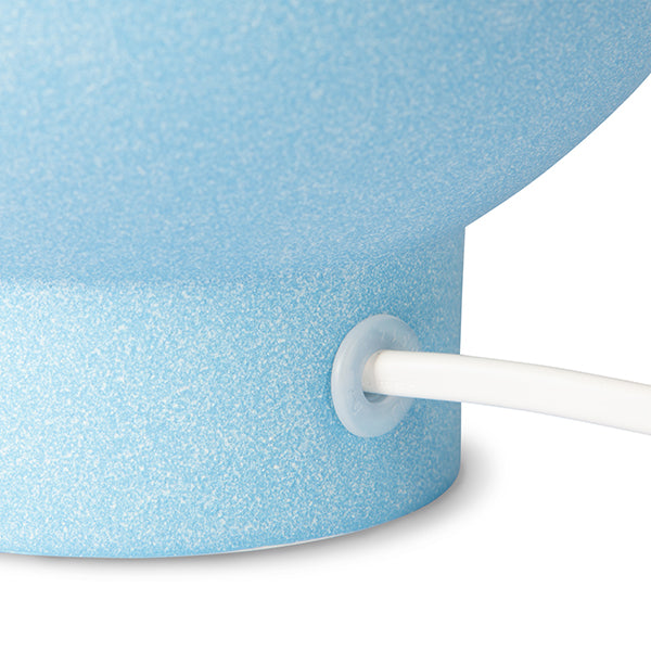 detail of ice blue lamp base with white cord