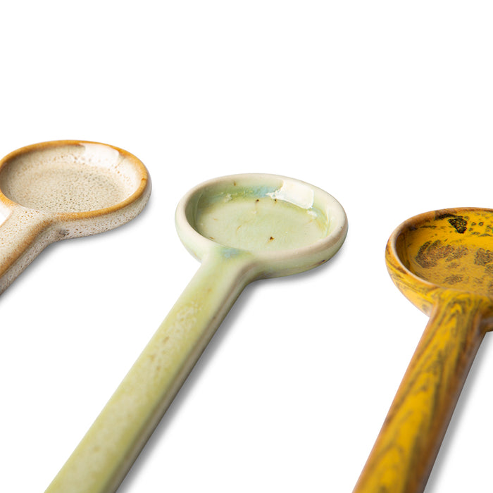 close up of 3 ceramic spoons with a retro design