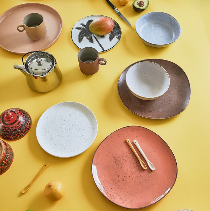yellow tabletop with peach and terra colored dinner plates