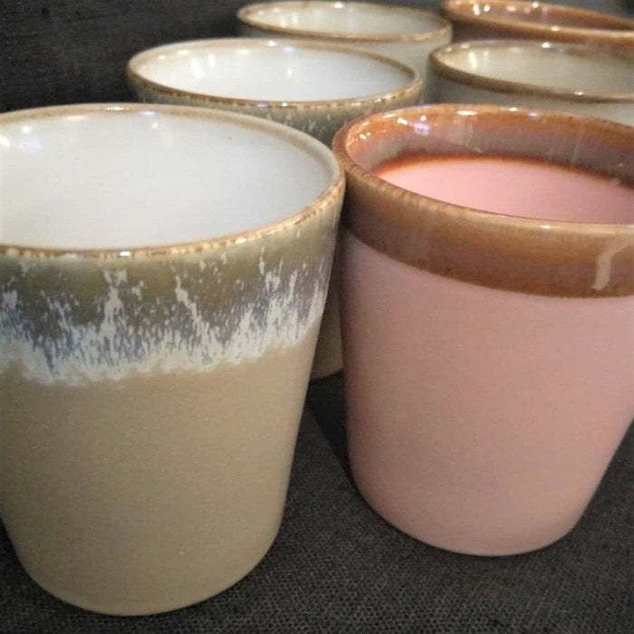 taupe colored and pink colored stoneware cups with reactive glossy glaze finish