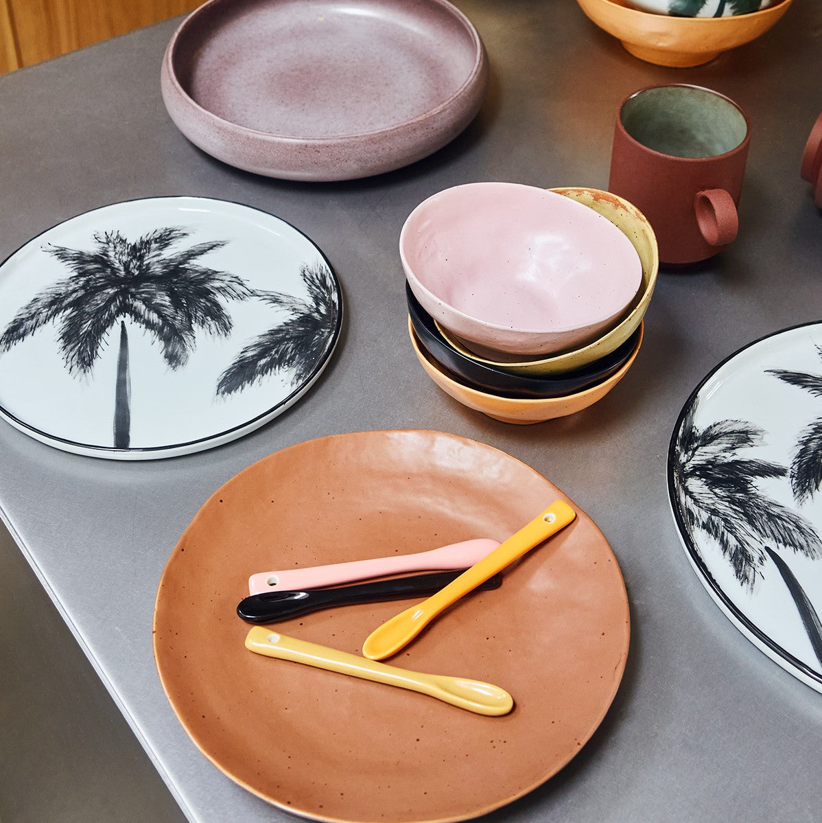 dinner plates in pastel colors with ceramic spoons 