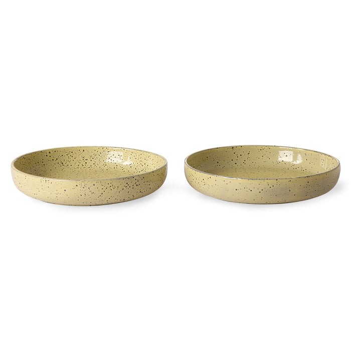 two yellow speckled deep paste plates