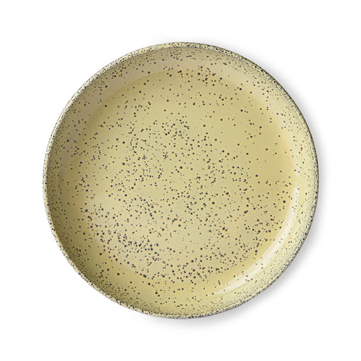 round yellow stoneware pasta plate with dark gray speckles