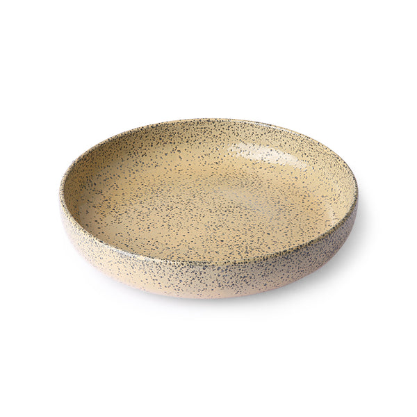 peach colored round deep plate made from speckled stoneware