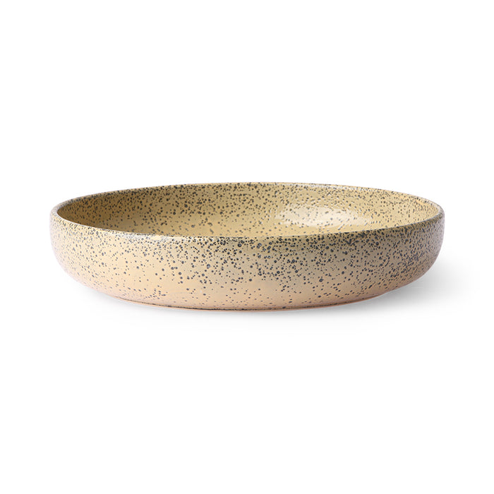 peach colored round deep plate made from speckled stoneware