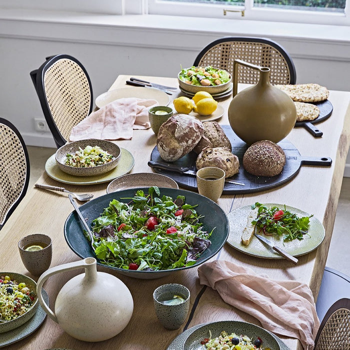 table setting with gradient ceramics in various colors in the mix 