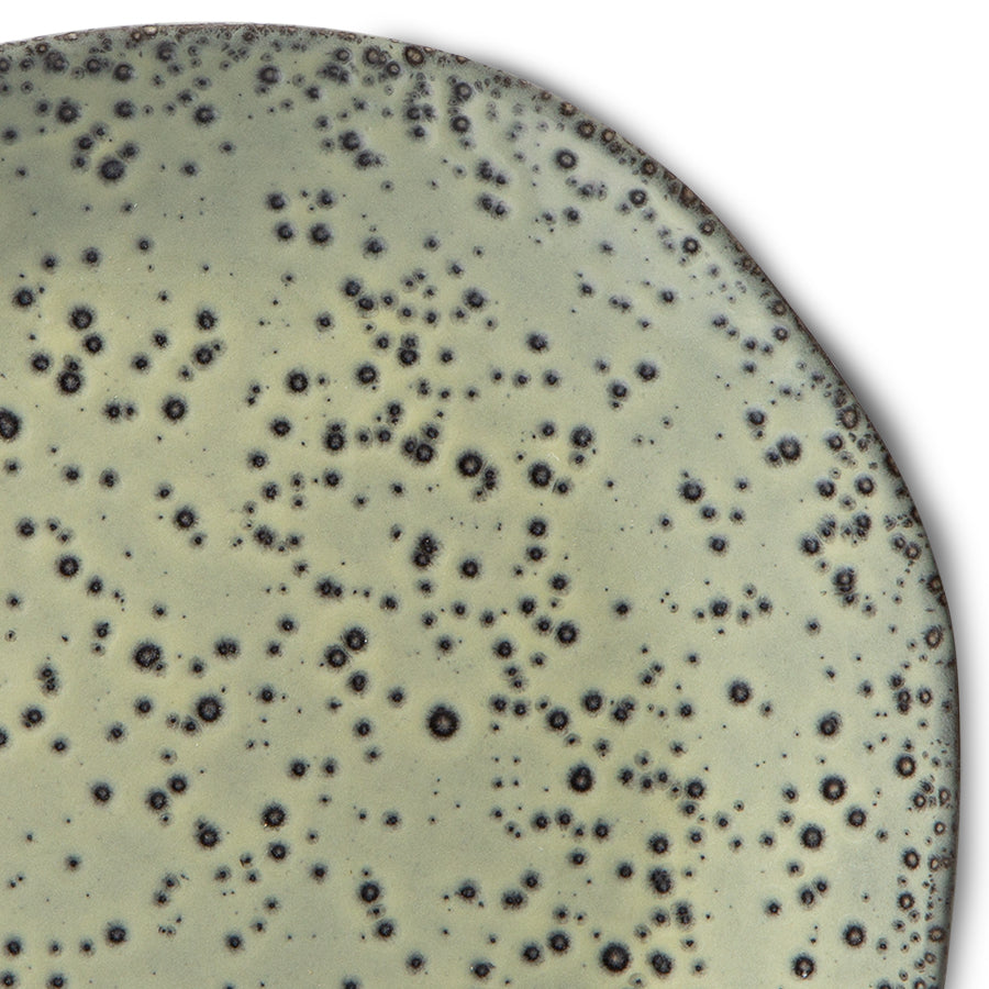 close up of stoneware green plate with reactive glaze