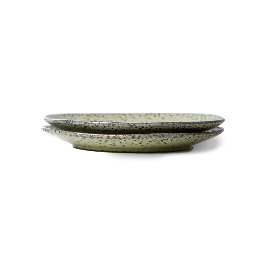 two green colored dessert plates on top of eachother