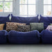 blue sofa with mix of vintage look pillows
