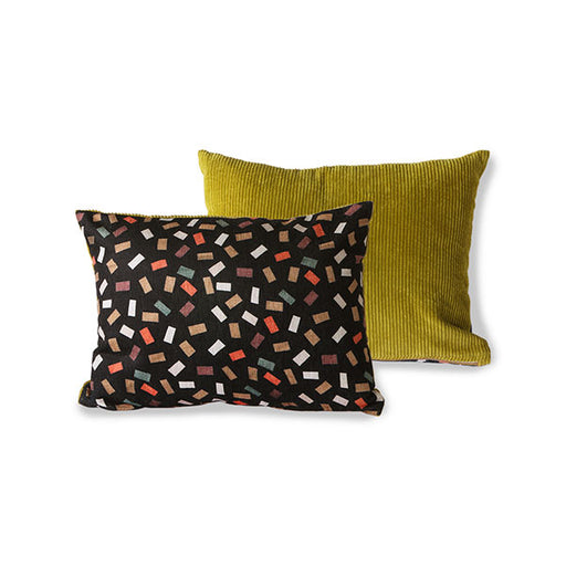 vintage look pillow with black and collared flakes pattern and green  corduroy back