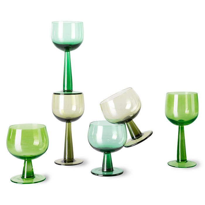 6 wine glasses in different shades of green with tall and short stems