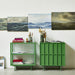 two fern green small sideboards next to eachother with paintings above them on the wall