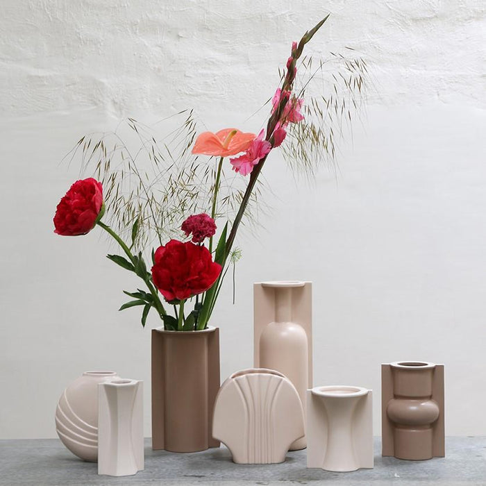 mocha and clay colored flower vases with red and pink flowers