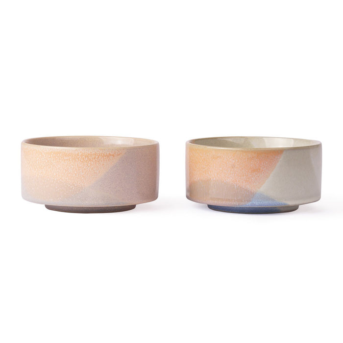 two bowls with differnt finishes in peach , blue and cream colors