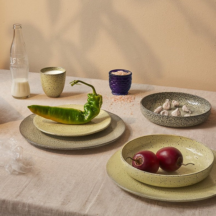 yellow speckled ceramic side plate with a green pepper and a cup of milk