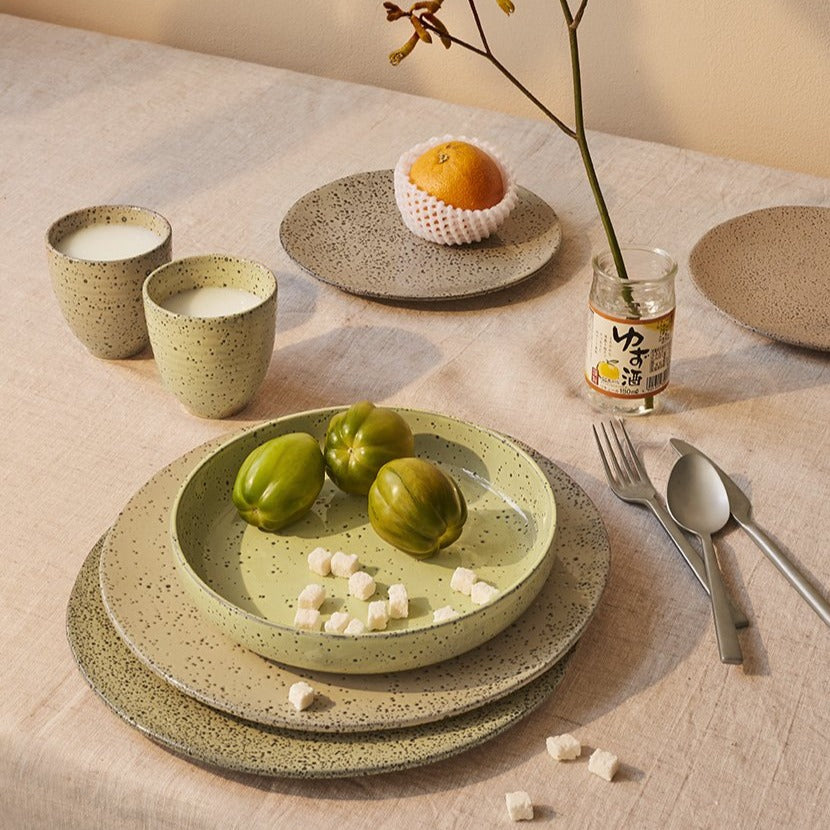 gradient ceramics table setting with yellow plates and tumbler mugs