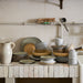 farmhouse style kitchen with speckled gradient ceramics stacked on counter
