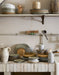 vintage style kitchen with organic shape speckled ceramics in earth colors