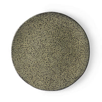 green ceramic dinner plate with a speckled finish