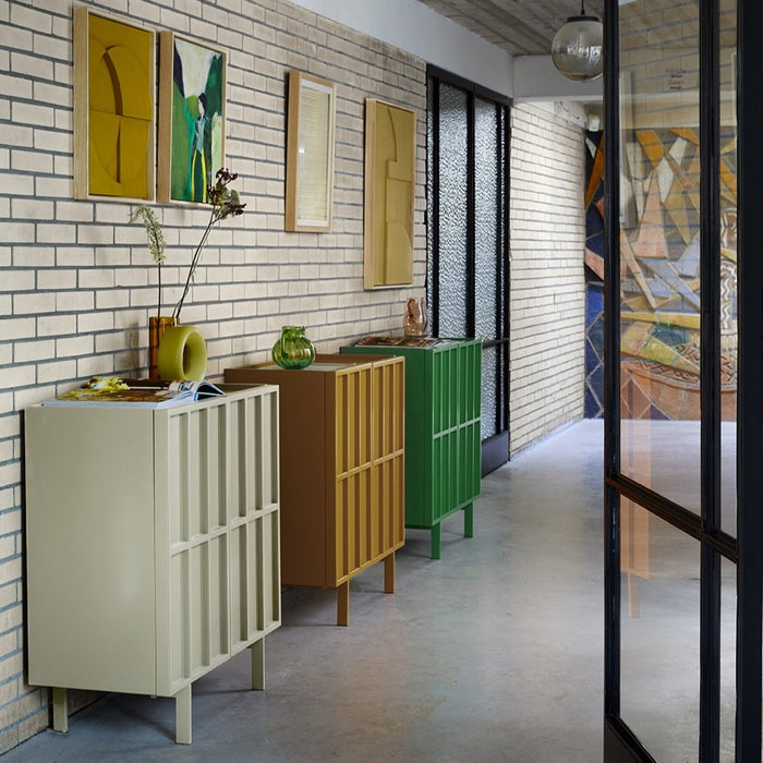 entry way with 3 small free standing sideboards in various colors