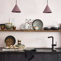kitchen with open shelving and ceramic plates bowls and cups