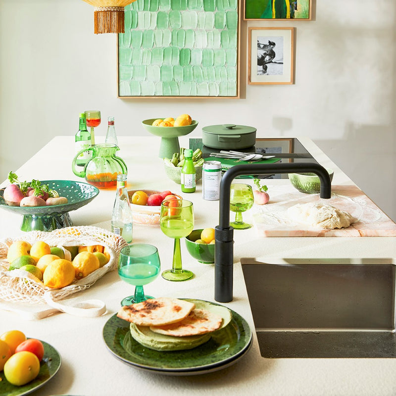 kitchen island with food prepping in green kitchenware