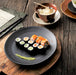 black plate with flat finish filled with sushi