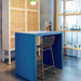 blue tiled bar with brass colored counter stool