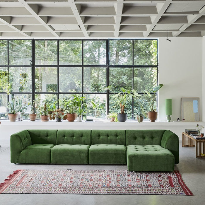 large green sectional sofa with pistachio green table lamp in window frame