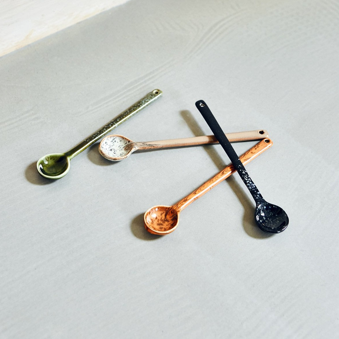 4 delicate ceramic spoons on a table