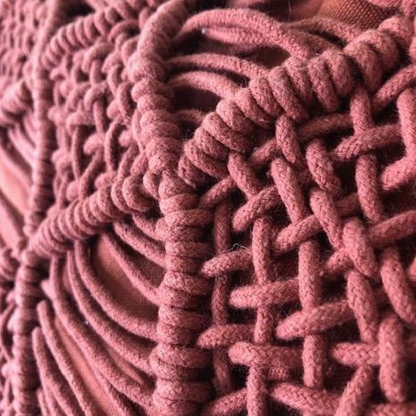 detail of coral red textured pillow
