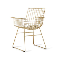 brass colored tub chair with arms made of metal