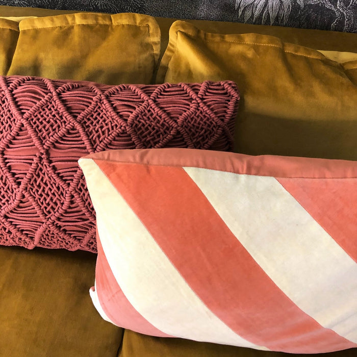 textured cotton and velvet pillows combined on velvet sofa