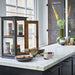 kitchen with marble counter top and black wooden display cabinet with mugs in retro design