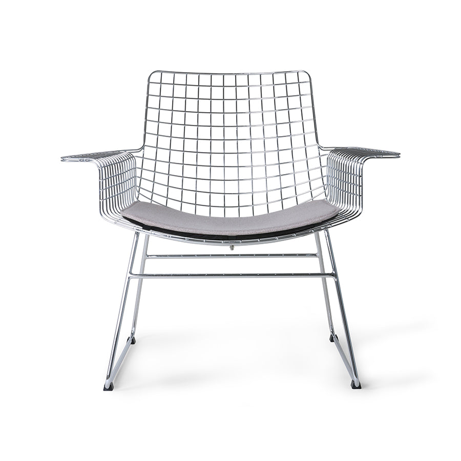 mid century modern style armrest chair in chrome with seat cushion in a light color