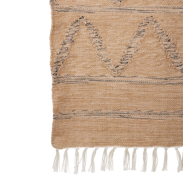 detail of neutral rug for outdoor use with fringes