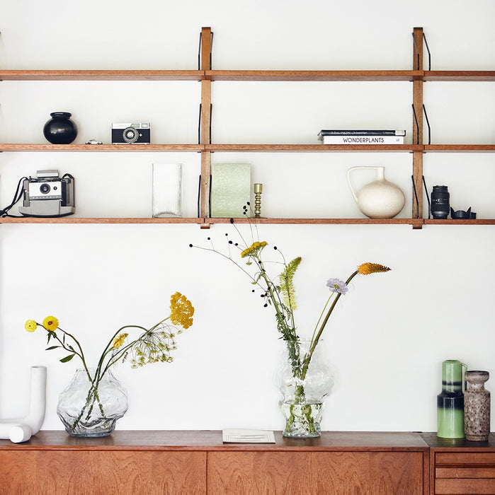 open shelving with clear glass cloud vases 