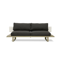 olive colored modern style outdoor sofa with black cushions