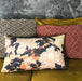 detail of lumbar pillow with flower print in natural colors