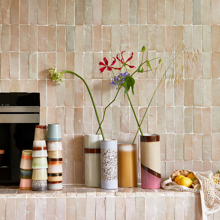 retro style vases against a beige tile wall
