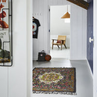 modern farmhouse style hallway with rose kelim rug, basketball, chair and hanging lamp