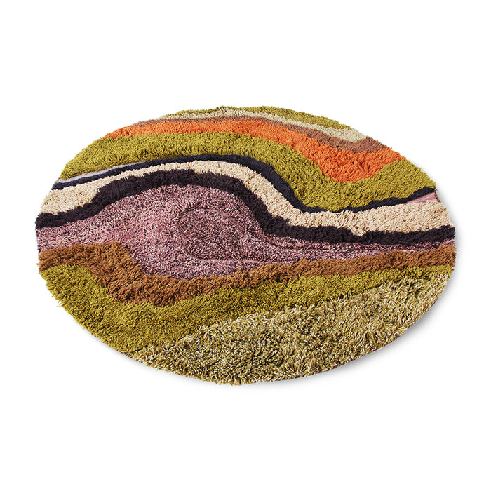 round rug made from wool in muted colors like mustard yellow, purple, orange and cream