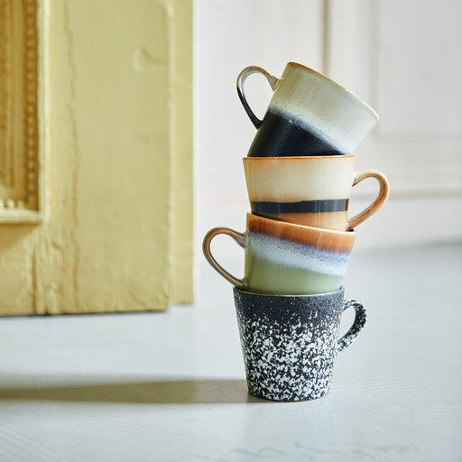 stack of 4 colorful ceramic coffee mugs with an ear