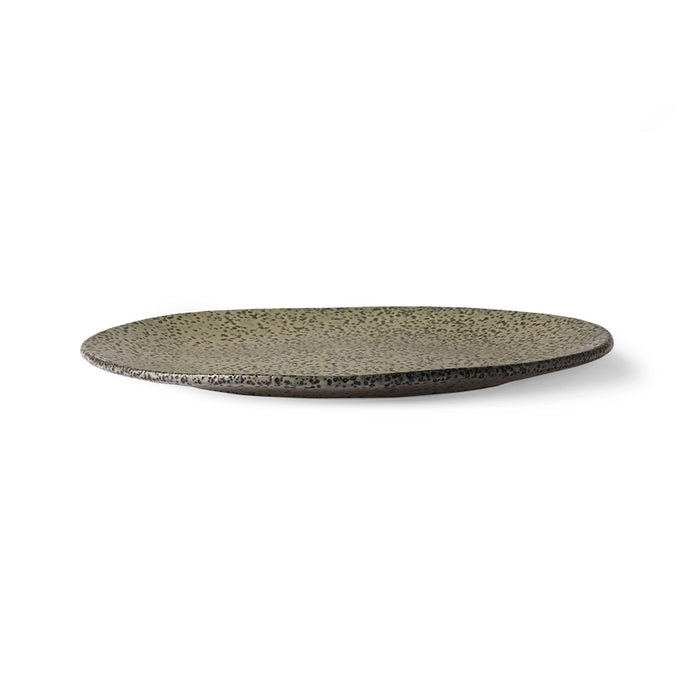 side view of a green speckled salad plate