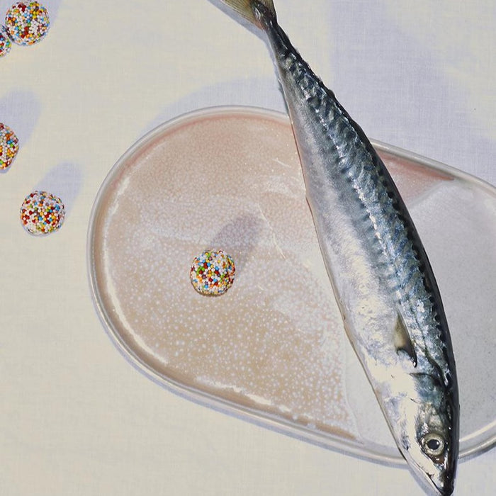 fish on an oval shaped plate with candy