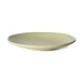 side view of a stoneware side plate in soft green
