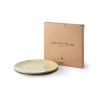 two yellow ceramic plates with a carton gift box